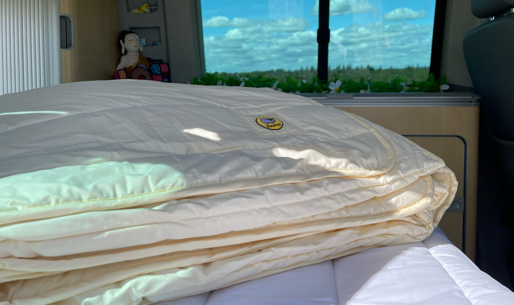 Image of a Baavet Duvet on top of a Baavet Mattress Protector in the back of a Volkswagen California.